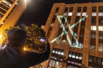 Twitter's new logo is seen projected on the corporate headquarters building in downtown San Francisco, California